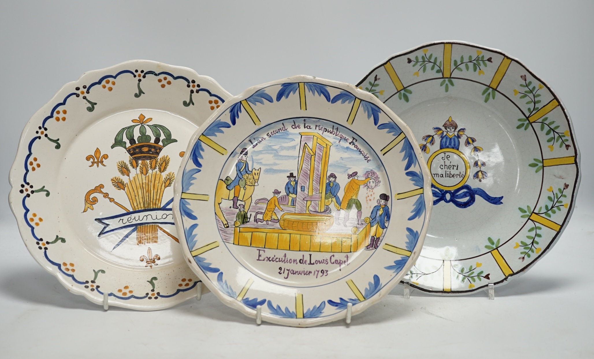 A collection of twenty 18th/19th century French faience polychrome and blue and white Revolution commemorative plates and three others, largest 27cm diameter (23)